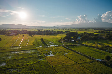 Aerial view of drone flying above rice field and farming in Chiang Rai province, Thailand - 571162401
