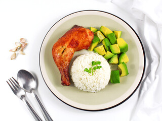 Grilled chicken on white plate with avocado and rice.