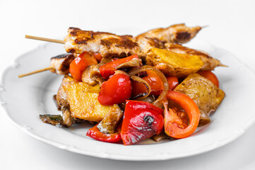 Souvlaki, pork meat on skewer on baked juicy vegetable.