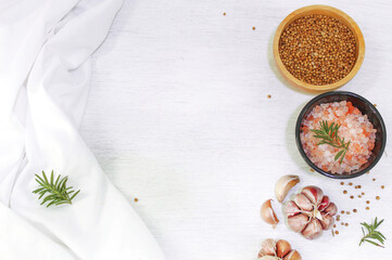 Pink organic himalaya salt and coriander seeds on white background, food concept.