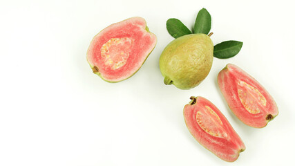 Fresh pink guava fruit, pieces and leaves isolated on white background.