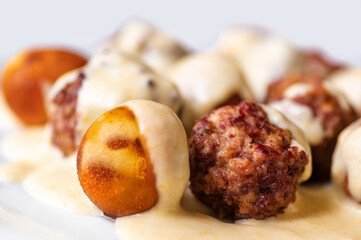 Baked meatball from beef, croquette in lemon sauce.