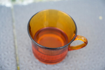 Brown transparent mug with little water