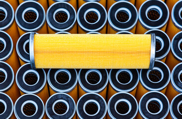 New yellow machine filters, stacked to each other and one filter on top of them.