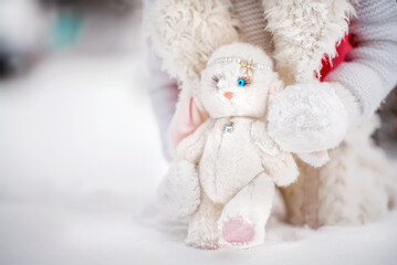 A little girl is playing with a toy hare. Winter. Snow. Tender baby. Baby portrait.
Toy Bunny Tenderness