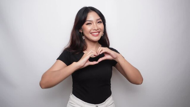 Asian beautiful smiling girl showing love sign with hand isolated white background. Indonesian Women