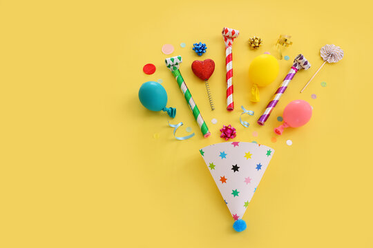 Top view image of party and present objects on yellow background