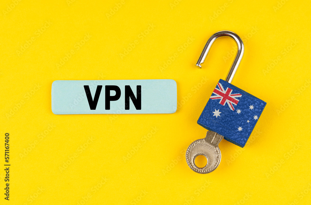 Poster on the yellow surface is an open lock with a key and a sticker with the inscription - vpn