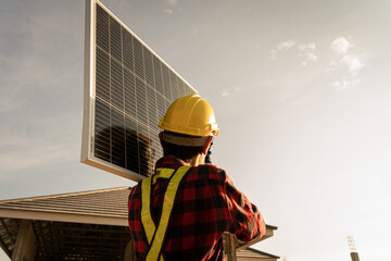 Engineers in helmets installing solar panel system outdoors. technician use a the Electric drill...