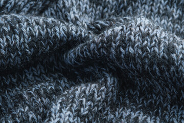 Texture knitted background. Folds of knitted woolen fabric close-up.