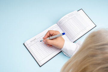 Woman pilot enters data into the logbook