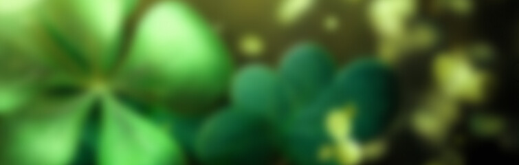 St Patrick day blurred background. Abstract green background decorated with shamrock leaves.