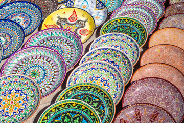 Decorative ceramic plates with traditional uzbek ornament in the street market of Bukhara....