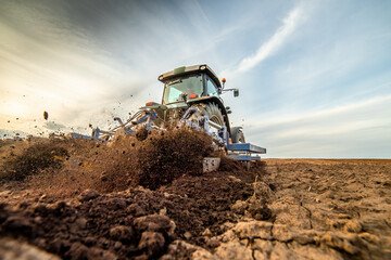 The art of farming, tractor tilling the soil for a successful planting season - obrazy, fototapety, plakaty