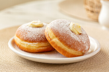 Close-up of Krapfen or berliner, or doughnut, or bombolone with cream filling, sugar powdered. - Powered by Adobe
