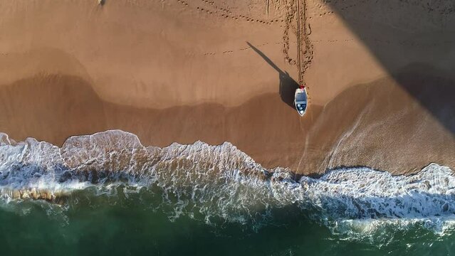 Little boat at sea in Praia Nova, from Aerial view.