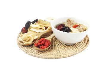 Chinese traditional nourishing healthy food - a white bowl of clear soup with Chinese herbal medicine - ginseng, gojiberry isolated on white background.