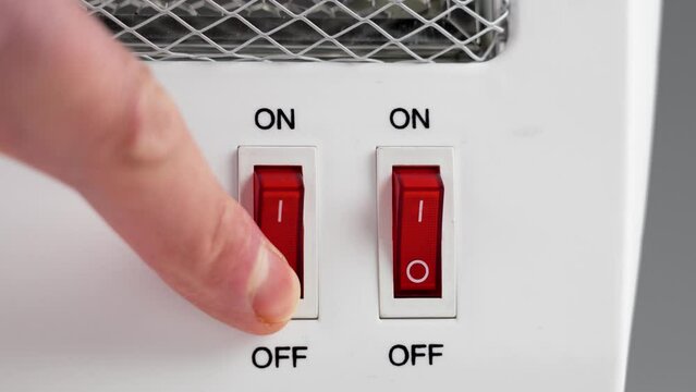 Turning off the heating home electric heater closeup. Saving electricity consumption due to the energy crisis
