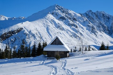 Beautiful winter scenery of Hala Gasienicowa (Valley Gasienicowa) withshepherd's hut in Tatras Mountains, Zakopane, Poland, Tatra National Park. 