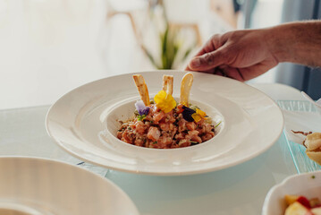 A creative version of salmon tartare with quinoa and avocado