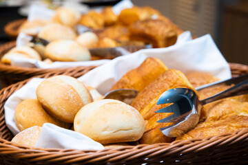 A lot of table rolls and square bread in the basket