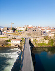 Aerial view of Barcelos city, district Braga, Portugal. Landscape on the river Cavado, Barcelos bridge, Paco dos Condes, water mill and church.