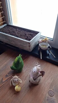 Planting onions in ground in spring. Little woolen toys came to life. Stop motion is animated filmmaking technique, objects are physically manipulated in small increments between photographed frames.