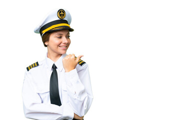 Airplane pilot woman over isolated chroma key background pointing to the side to present a product