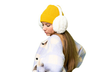 Young blonde woman wearing winter muffs over isolated chroma key background suffering from backache for having made an effort