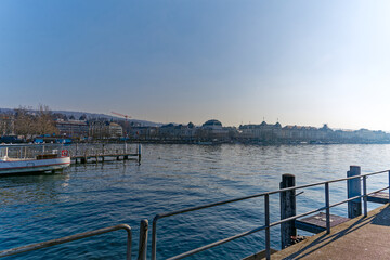 Fototapeta na wymiar Scenic view of Lake Zürich with skyline in the background seen from pier at City of Zürich on a sunny winter day. Photo taken February 9th, 2023, Zurich, Switzerland.