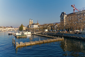 Scenic view of Limmat River with Minster Bridge and the skyline of the old town of City of Z&uuml;rich with church Great Minster on a sunny winter day. Photo taken February 9th, 2023, Zurich, Switzerland.