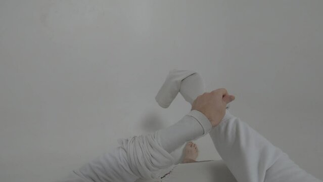  Point of view shooting of a violent psychiatric patient freeing his hands from  straitjacket  in white ward of asulym , going to escape from clinic