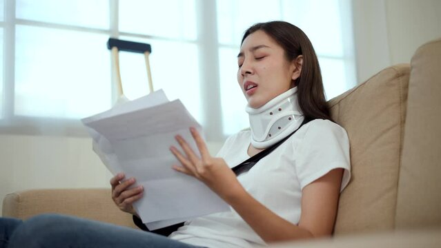 UnHappy woman stressed pay invoice medical expenses from accident fracture broken bone injury with leg splints in cast, neck splints collar, sling support arm. Social security and health insurance.