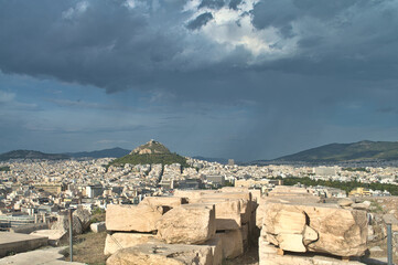 View from Acropolis to Mount Lycabettus and stormy sky - Athens, Greece.
