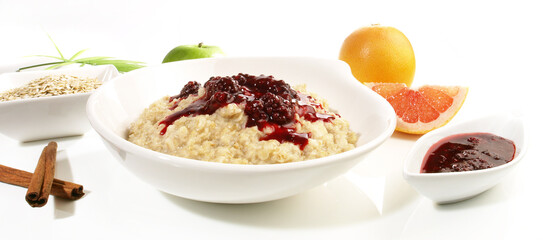 Porridge in a white Bowl; Oatmeal with Berrys an Cinnamon isolated on white Background - Panorama