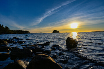 Fototapeta na wymiar sunset over stone beach and lake Vattern Motala Sweden