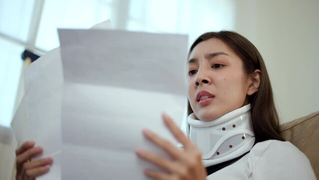 UnHappy woman stressed pay invoice medical expenses from accident fracture broken bone injury with leg splints in cast, neck splints collar, sling support arm. Social security and health insurance.