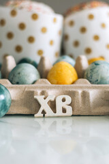 Easter cakes, eggs and the letters Christ is Risen on the table. Orthodox Christians. Vertical photo.