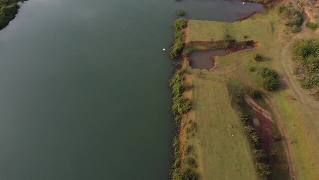 Aerial Footage and Drone 4k of a Green River Bank with Clean Water in Tropical Region, Summer Vacation, Nature, Tropical Holidays , India, Pune, Bhor, Maharashtra