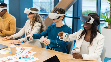 Business conference in VR in an office. Multiracial group of people using VR glasses and...