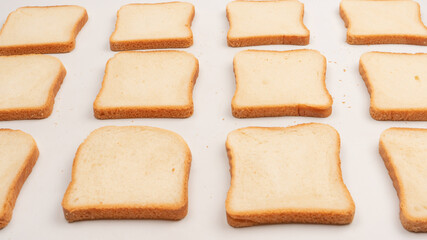 Delicious bread slices isolated on a white background, top view.