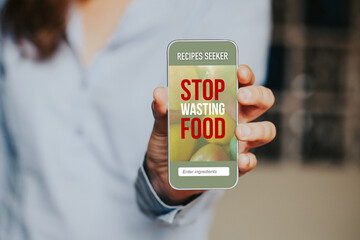 Stop Wasting Food letters in a mobile phone screen and woman holding it.