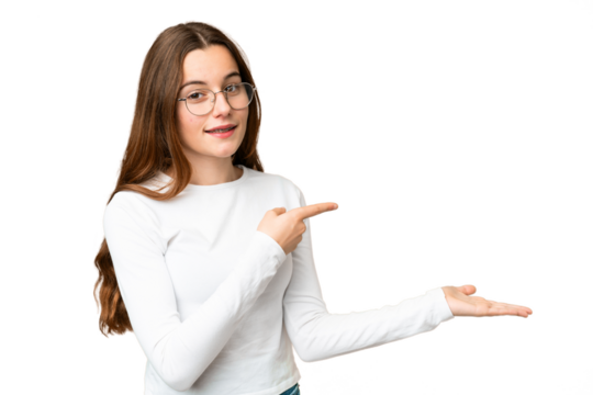 Teenager girl over isolated chroma key background holding copyspace imaginary on the palm to insert an ad