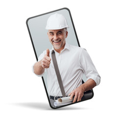 Cheerful construction engineer giving a thumbs up in a smartphone videocall and smiling, online ...