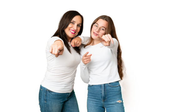 mother and daughter over isolated chroma key background points finger at you with a confident expression