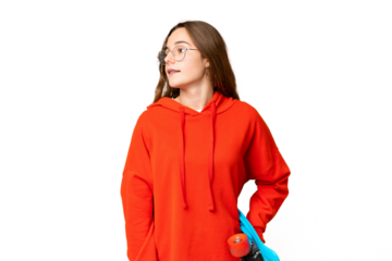 Teenager girl over isolated chroma key background with a skate