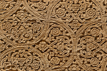 Fototapeta na wymiar Fragment of an ancient carved wooden door. Ornate.