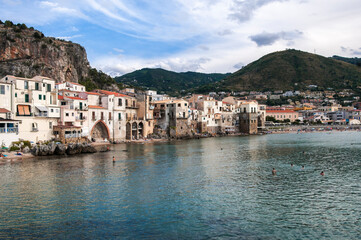 The fishing village of Cefalu in Sicily / The fishing village of Cefalu with its town beach on Sicily, Italy. - 571187248