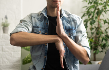 Man showing gesture in sign language on white background