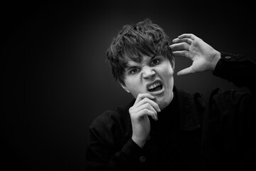 crazy young man with awesome hairdo grimacing